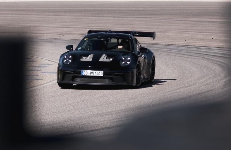 Image showing a black 2023 Porsche 911 GT3 RS testing on the race track