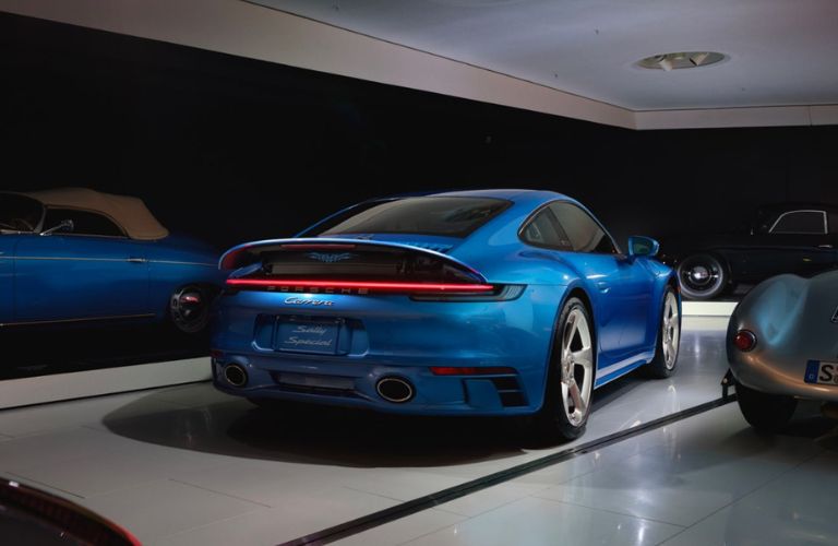Rear view of the blue-colored Porsche 911 Carrera Sally Special parked indoors.