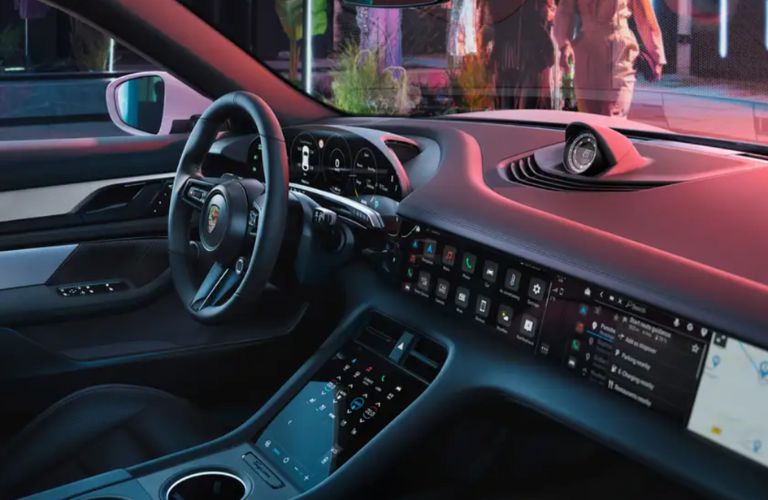 Interior steering wheel area of the 2022 Porsche Taycan is shown.