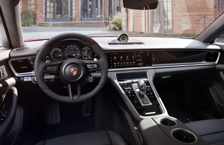 The steering wheel area of the 2023 Porsche Panamera is shown.