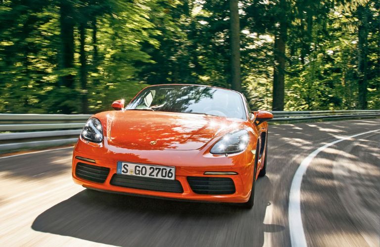 A 2016 Porsche Boxster taking a turn on a road